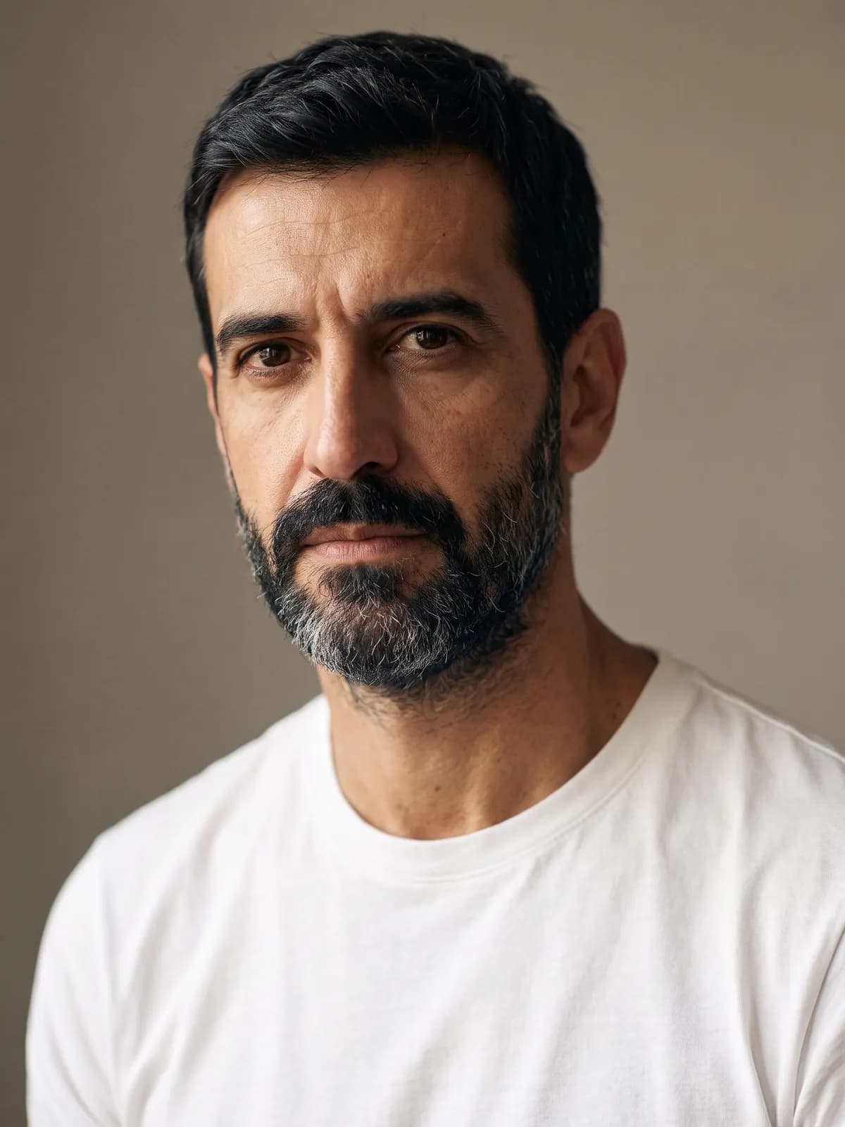 Portrait of Javier, looking past the camera, in soft side light